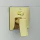 Wandmontierte Armatur in gebürstetem Gold von Ideal Standard, mit einem hebel und einem runden Drehknopf zur Steuerung des Wasserflusses.